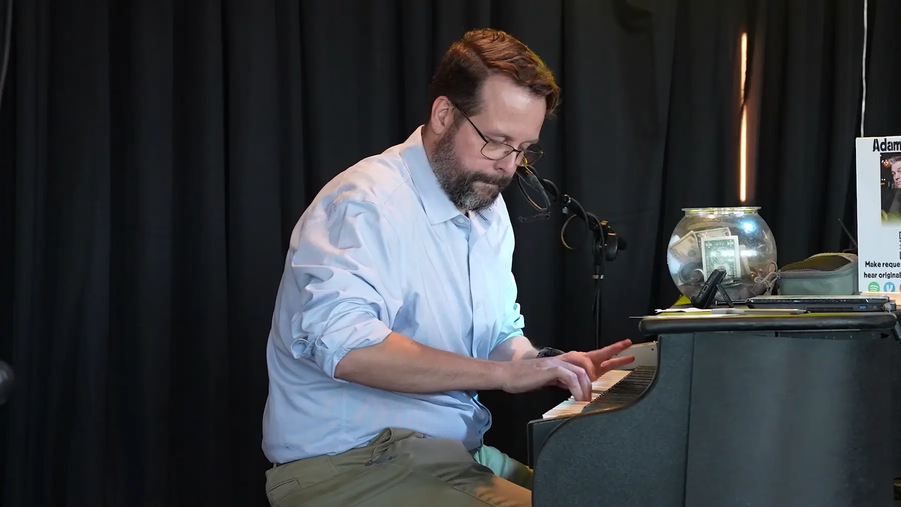 Elijah Hubbard playing piano in Midwest Dueling Pianos performance footage